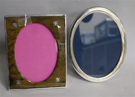 A George V silver and simulated tortoiseshell photograph frame, Birmingham, 1927 and a later silver mounted oval frame.